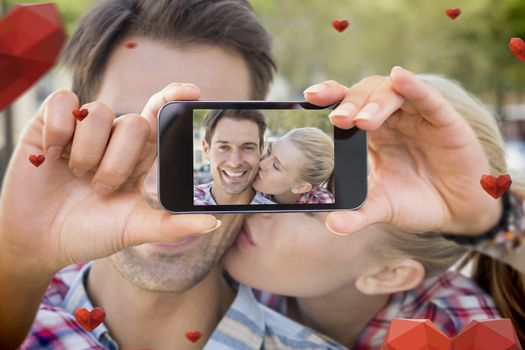 Composite image of valentines couple taking a selfie