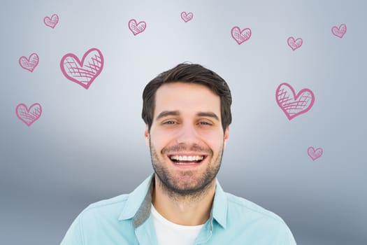 Happy casual man smiling at camera against grey vignette