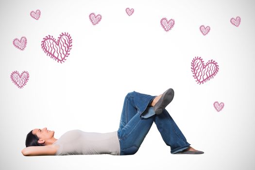 Young woman lying on floor thinking against white background with vignette