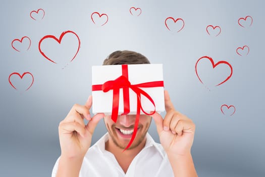 Man holding gift against grey vignette