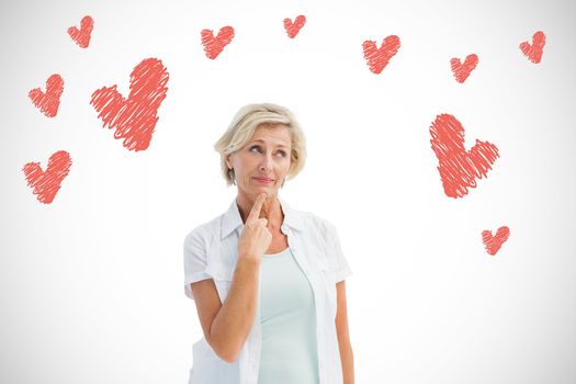 Mature woman thinking with hand on chin against white background with vignette