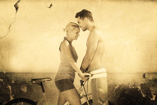 Cute couple together with their bicycles against grey background