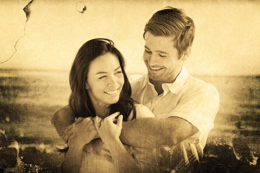 Cheerful couple relaxing on the beach during summer against grey background