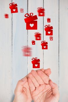 Hands presenting against painted blue wooden planks