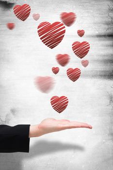 Businesswomans hand presenting against heart