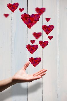 Hand showing against painted blue wooden planks