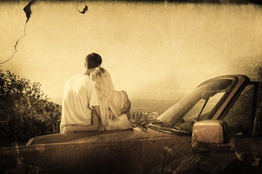 Rear view of couple hugging and admiring panorama against grey background