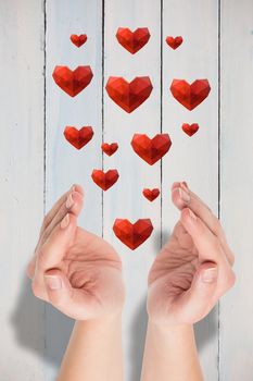 Hands presenting  against painted blue wooden planks