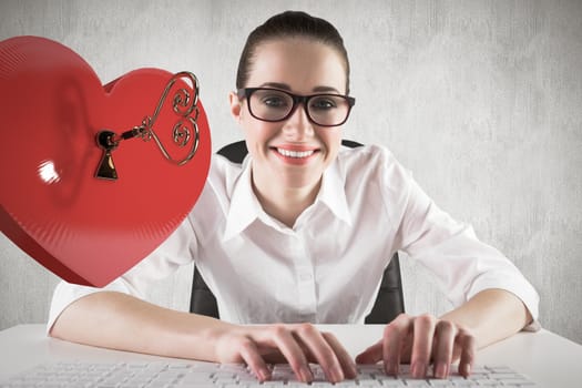 Businesswoman typing on a keyboard against white and grey background