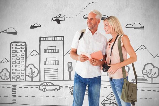 Happy tourist couple using the guidebook against white background