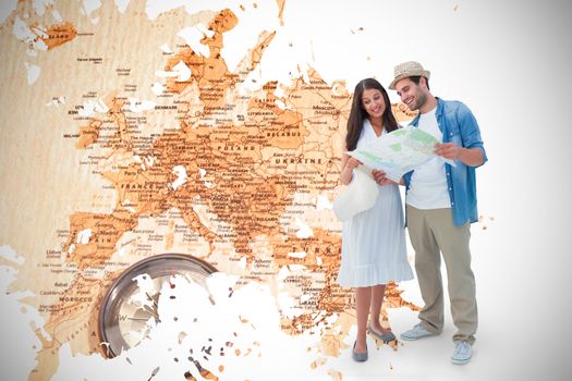 Happy hipster couple looking at map against world map with compass showing southern asia