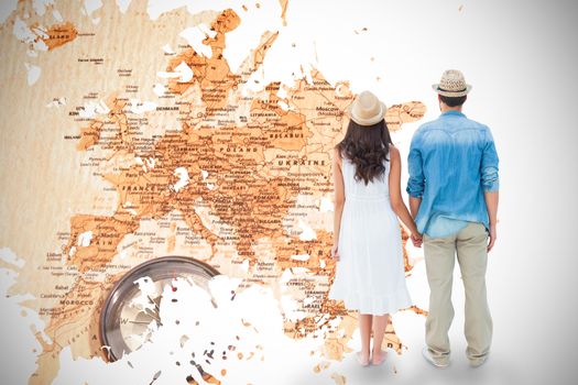 Happy hipster couple holding hands against world map with compass showing southern asia