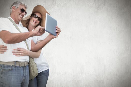 Vacationing couple taking photo against white background