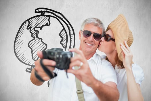 Vacationing couple taking photo against white background