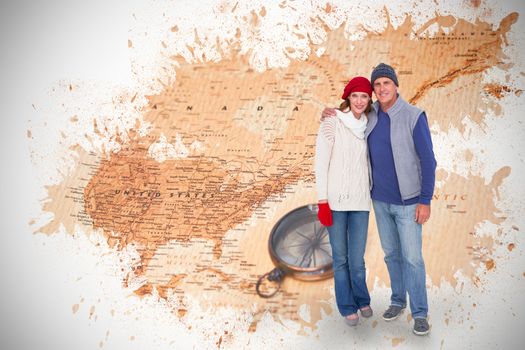 Happy couple in warm clothing against world map with compass showing north america