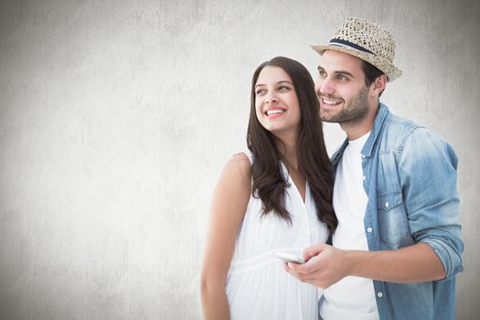 Happy hipster couple smiling together against white background