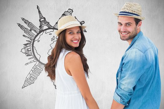 Happy hipster couple holding hands and smiling at camera against white background