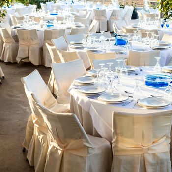 Table setting for an event party at outdoor cafe in the evening light