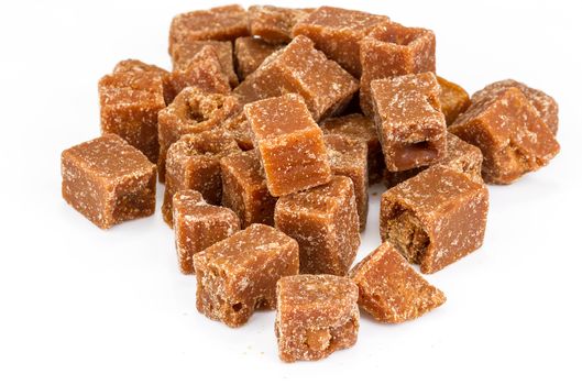 unclarified organic brown cane sugar cube on white background