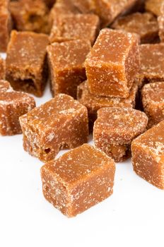 unclarified organic brown cane sugar cube on white background