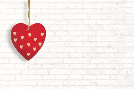 Cute heart decoration against white wall