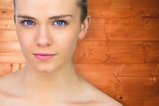 Serious blonde natural beauty against overhead of wooden planks