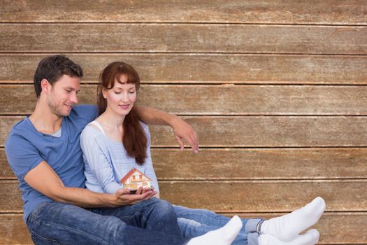 Couple using tablet at home against wooden planks background