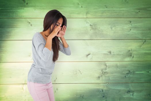 Pretty brunette shouting against wooden planks