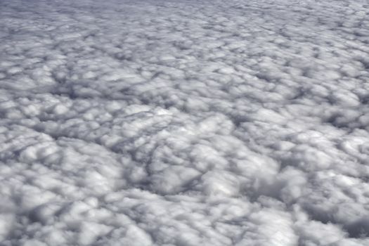 Fluffy rain clouds shot from an airplane