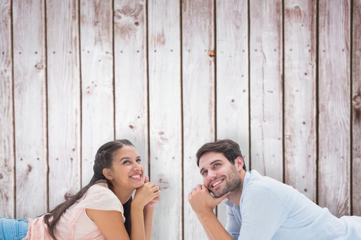 Attractive young couple looking up against wooden planks