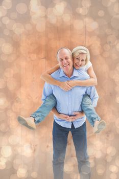 Mature man carrying his partner on his back against light glowing dots design pattern