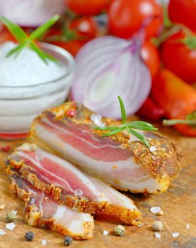 Smoked bacon and vegetables on wood table