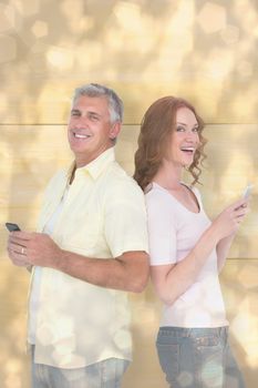 Casual couple sending text messages against light glowing dots design pattern