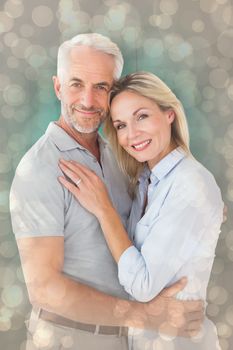 Happy couple standing and smiling at camera against light glowing dots design pattern