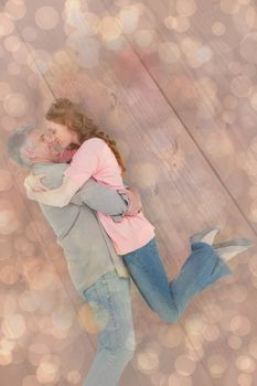 Casual couple hugging each other against light glowing dots design pattern