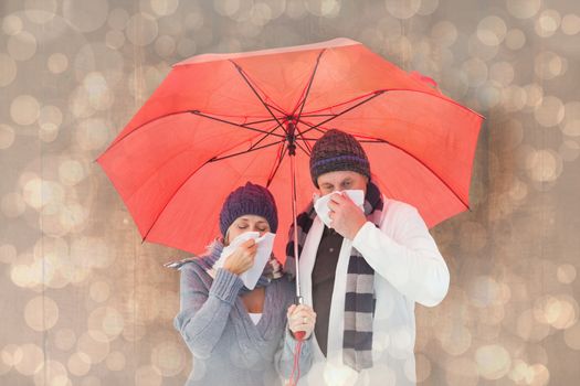 Mature couple blowing their noses under umbrella against light glowing dots design pattern