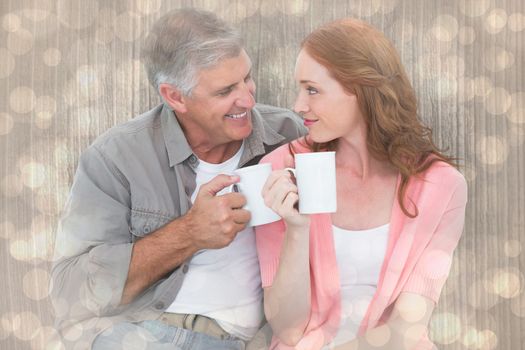 Casual couple having coffee together against light glowing dots design pattern