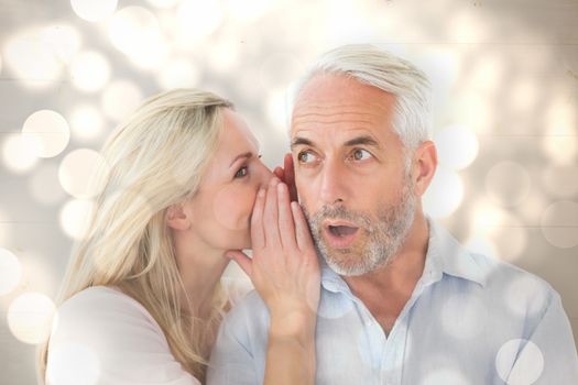 Woman whispering a secret to husband against light circles on bright background