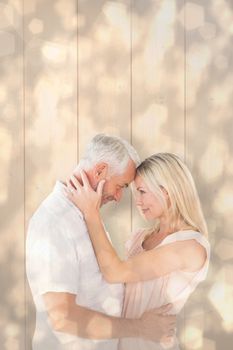 Affectionate couple standing and hugging against light glowing dots design pattern