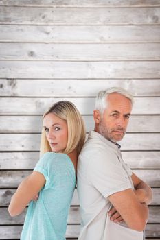 Unhappy couple not speaking to each other  against wooden planks