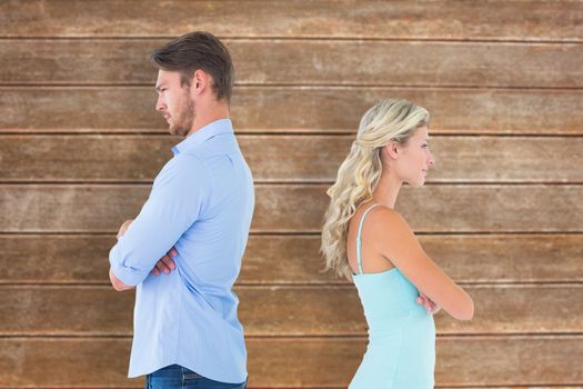 Unhappy couple not speaking to each other  against wooden planks background