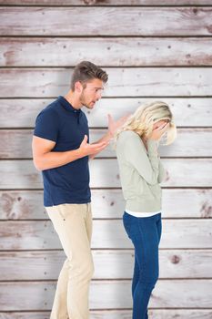 Young couple having an argument against wooden planks