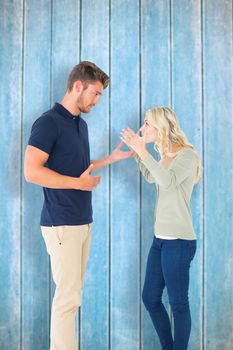 Young couple having an argument against wooden planks
