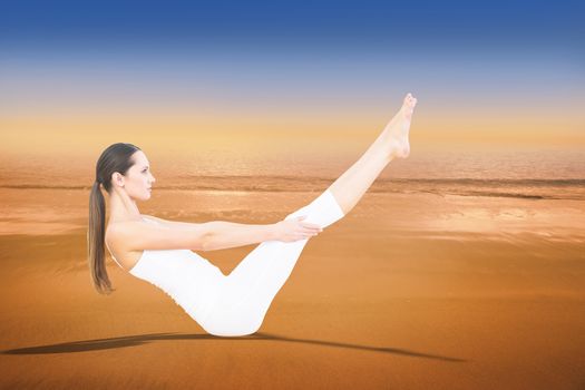 Toned woman doing the boat pose in fitness studio against hazy blue sky