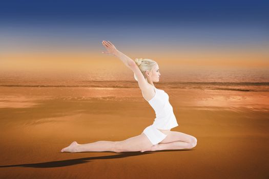 Toned young woman stretching hands backwards against hazy blue sky