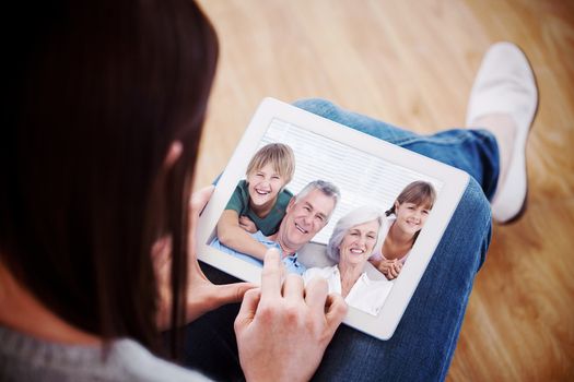 Composite image of grandchildren and grandparents sitting on couch