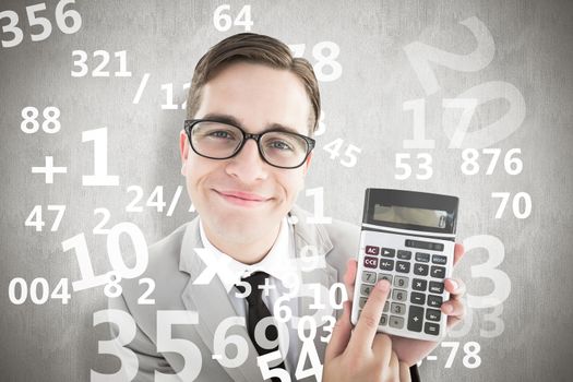 Geeky smiling businessman showing calculator against white background