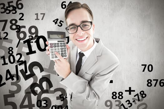 Geeky smiling businessman showing calculator against white background