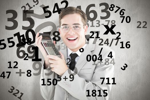 Geeky smiling businessman holding calculator against white background