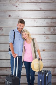 Attractive young couple ready to go on vacation against wooden planks
